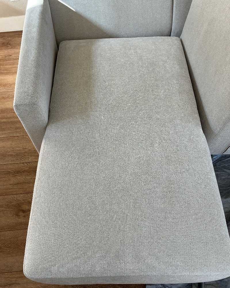 The same light gray sectional chaise cushion after professional upholstery cleaning